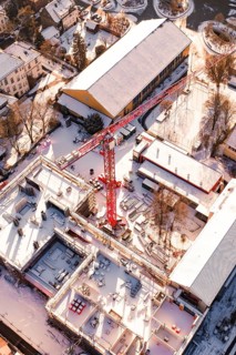 Detailed aerial view of a construction site in a snowy urban landscape, Zellerschule building,