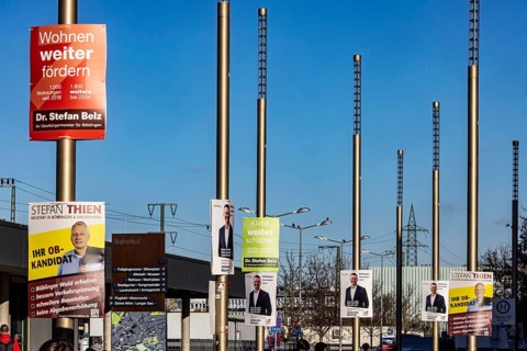 Mayor election in Böblingen. Election posters of OB candidates are hanging in front of the train
