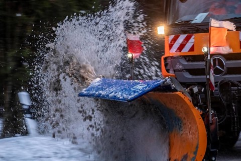 Winter service, spreader and snow plough in use, clears snow and slush from a regional road,