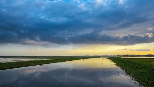 Sunset is reflected in the Hunte in Ochsenmoor at Dümmer See, Hüde, Lower Saxony, Germany