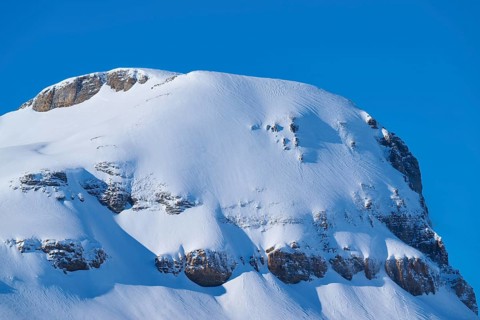 Snowy mountain with steep rocks under clear sky, Gemmi Pass, Leukerbad, Leuk, Valais, Switzerland