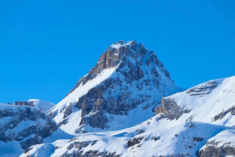 Snowy mountain peak under clear blue sky surrounded by rocks, Gemmi Pass, Leukerbad, Leuk, Valais,