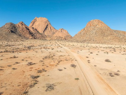 Aerial view, road and mountains in the desert, Spitzkoppe summit, Namib desert, Namibia