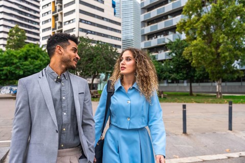 Business colleagues having a discussion while walking through a contemporary urban area, presenting
