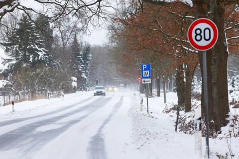 Road traffic in winter, icy road covered with snow with car traffic, risk of accident,