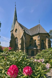 Church Apostelkirche - Evangelical-Lutheran parish Neuenkirchen-Vörden, church tower, shrub