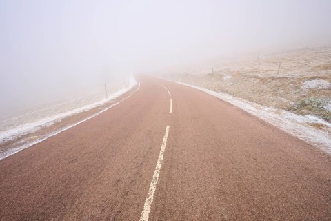 Gentle curve of a road in thick fog, winter, Route de Cretes, Hohneck, La Bresse, Vosges, France