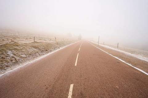 Deserted road leading into thick fog, winter, Route de Cretes, Hohneck, La Bresse, Vosges, France