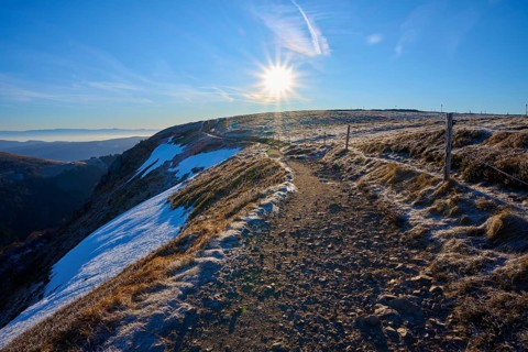 Snowy trail on a ridge at sunrise, clear view with frosty landscape, winter, Route de Cretes,