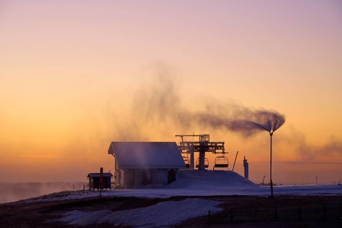 Snow cannons produce fog in orange sunset, winter, Route de Cretes, Hohneck, La Bresse, Vosges,