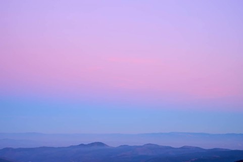Mountain range under a calming sky in pastel shades of purple, pink and blue, looking at, Rhine