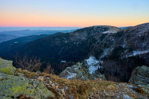 Snowy hills and rocks in warm evening light, view of the Rhine Valley, viewpoint, La Gorge de