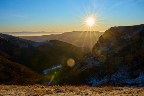 Sunrise over a snowy mountain valley with clear sky and rays of light, morning, winter, Hohneck, La
