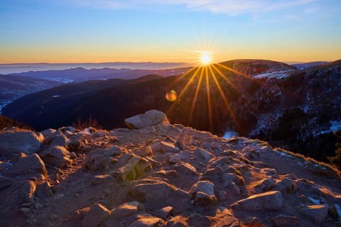 Rocks on a mountain peak at dawn under a setting sun, looking towards the Rhine Valley, viewpoint,