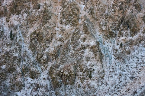 Rocky, snowy mountain wall with complex texture and cold winter atmosphere, Hohneck, La Bresse,