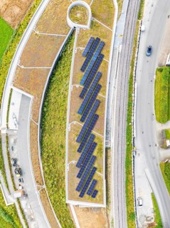 Flat roof with solar panels and surrounding infrastructure from a bird's eye view, new Park and