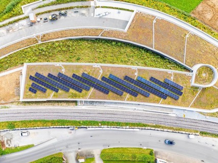 Solar panels on a flat roof surrounded by roads and vegetation, new park and ride car park Calw