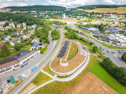 Wide view of an area with solar systems, surrounded by residential and commercial areas, new park