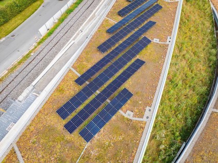 Close-up of solar panels on a green hill in urban surroundings, new park and ride car park Calw