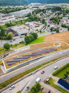 View of urban landscape with solar panels and road traffic, new park and ride car park Calw