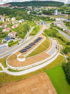 Urban landscape with green roof and solar system, surrounded by roads and nature, new park and ride