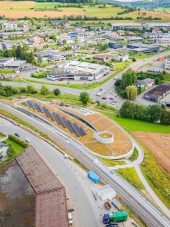Overview of a commercial area with solar systems nestled in rural surroundings, new park and ride