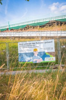 Construction site with advertising for photovoltaic systems for regional power generation under
