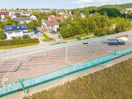 Construction site for solar systems in a quiet residential area with green areas and sun, new park