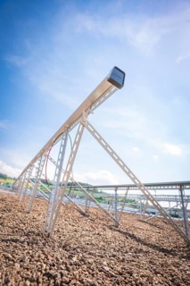 Close-up of a metal structure for solar modules under a clear blue sky, new park and ride car park