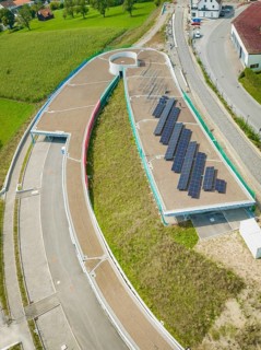 Round road layout next to solar panel system on a roof, new Park and Ride Calw Heumaden car park on