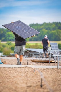 Workers transport and install solar panels in the open air, new park and ride Calw Heumaden car