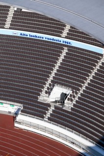 Modern stadium stand with empty seats, outdoor stairs and tartan track, Helsinki Olympic Stadium,