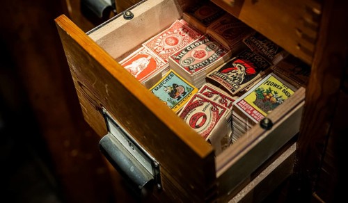 Historical matchbox labels, various motifs, in wooden drawer, Tändsticksmuseet matchstick museum or