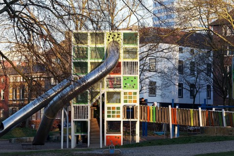 Children's playground with colorful climbing tower and slides, Immanuel-Kant-Park, Duisburg, North