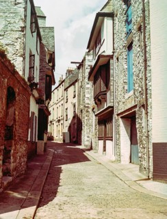 Historic buildings cobbled street including listed Elizabethan House with distinctive jettied,
