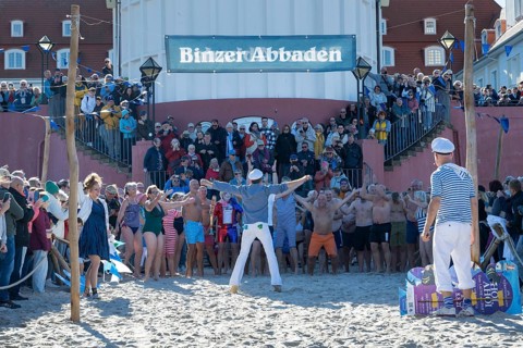 Tourists waiting in front of the spa hotel to bathe, swimmers ready to start in the water, tourist