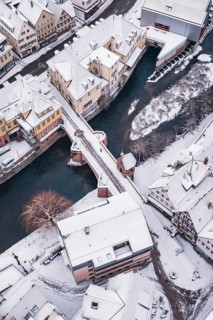 Snowy city view with a bridge across a river, Calw, Black Forest, Germany