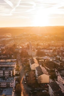 Aerial view of a city at sunset, warm colors, modern buildings and roads, Calw, Black Forest,