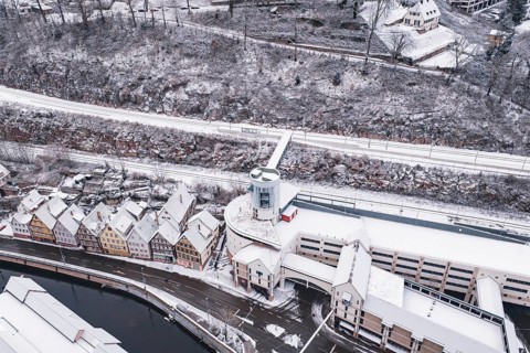 Snowy city view with bridge over a river and traditional architecture, Calw, Black Forest, Germany