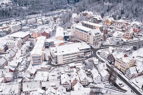 A snowy district with closely located buildings and roads, Calw, Black Forest, Germany