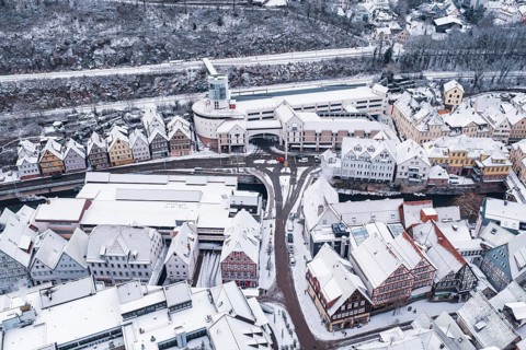 Aerial view of a snowy town with half-timbered houses and roads in winter, Calw, Black Forest,