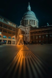 Illuminated St Paul Cathedral with decorated Christmas tree and festive night atmosphere, London,