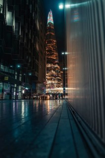 Tall illuminated skyscraper, people on the street, Shard, London, England, Great Britain