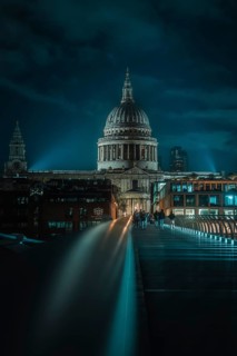 St Paul Cathedral with illuminated bridge in the foreground and urban night atmosphere, London,