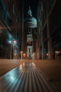 Illuminated St Paul Cathedral through a modern narrow path with a symmetrical angle, London,