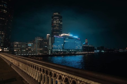 City view at night with glowing buildings and a bridge over a river, London, England, Great Britain