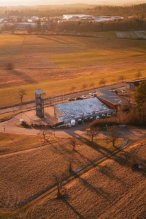 Fire station in a rural winter landscape with long shadows and snow-covered fields, Althengstett,