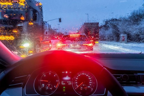 Driving in winter, in snow, rain, rear lights, brake lights, speedometer, cockpit
