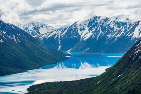View of snowy mountains in spring and turquoise Kenai Lake with reflection, Slaughter Ridge Trail,