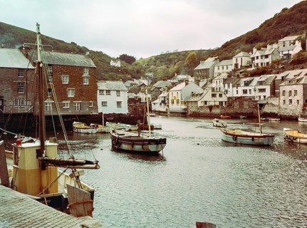 Historic waterfront buildings around the harbour river mouth of the River Pol at village of